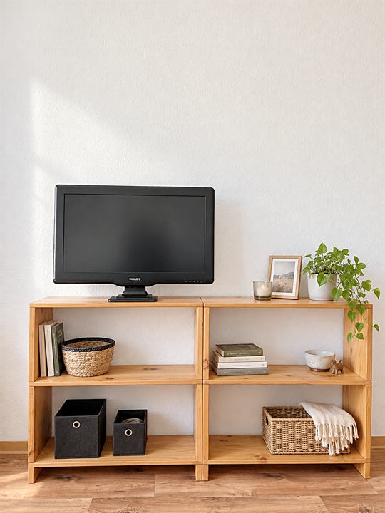 Regal mit Fernseher an der weißen Wand
